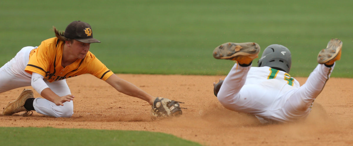 East Union's Jude Treadaway (10) tries to tag Taylorsville's Ty Keyes (13) at second base. East Union and Taylorsville played in game 2 of the MHSAA Class 2A Baseball Championship on Friday, June 4, 2021 at Trustmark Park. Photo by Keith Warren