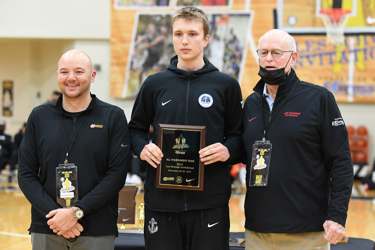 Les Schwab Invitational co-founder Nick Robertson (right) poses with Lake Oswego standout freshman Winters Grady for 2021 all-tournament awards.