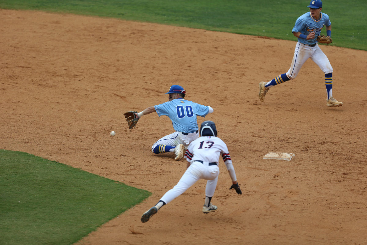 Tupelo Christian's John Paul Yates (13) slides safely into second base as Resurrection's Will Clemens (00) attempts to catch the ball. Tupelo Christian and Resurrection played in game 1 of the MHSAA Class 1A Baseball Championship on Tuesday, June 1, 2021 at Trustmark Park. Photo by Keith Warren