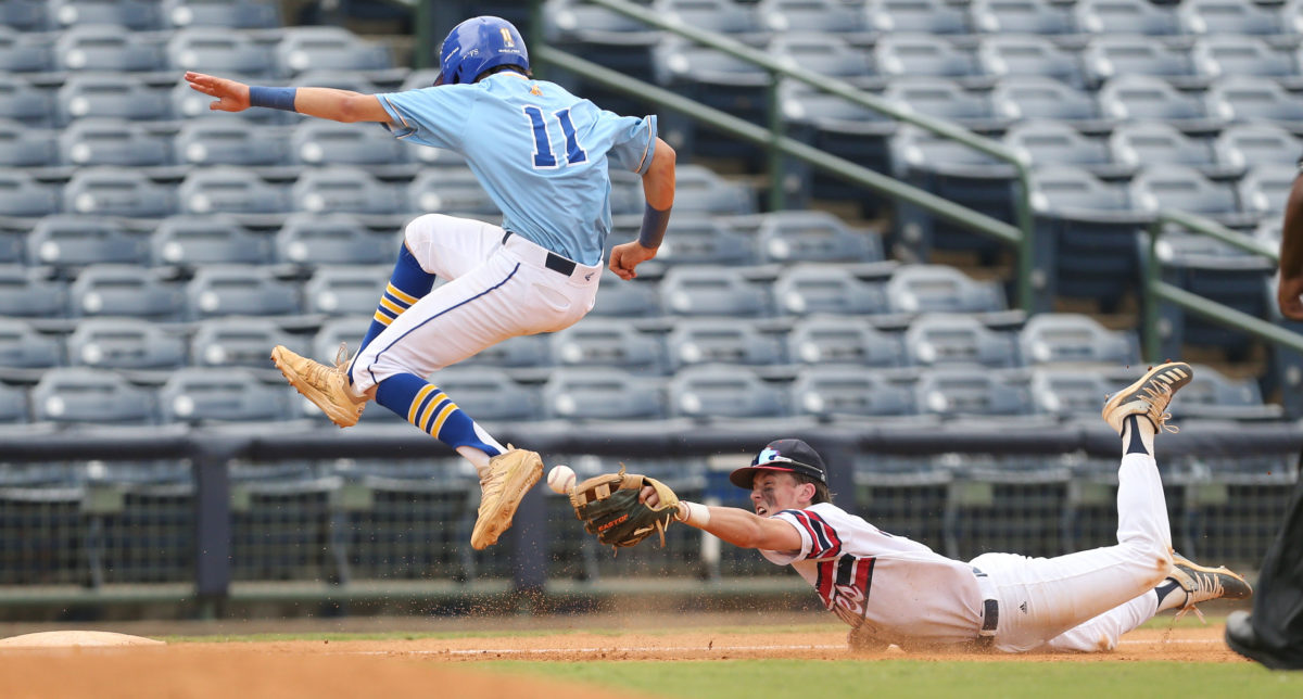 Resurrection's Luke Schnoor (11) avoids a tag by Tupelo Christian's John Paul Yates (13) at third base. Tupelo Christian and Resurrection played in game 1 of the MHSAA Class 1A Baseball Championship on Tuesday, June 1, 2021 at Trustmark Park. Photo by Keith Warren