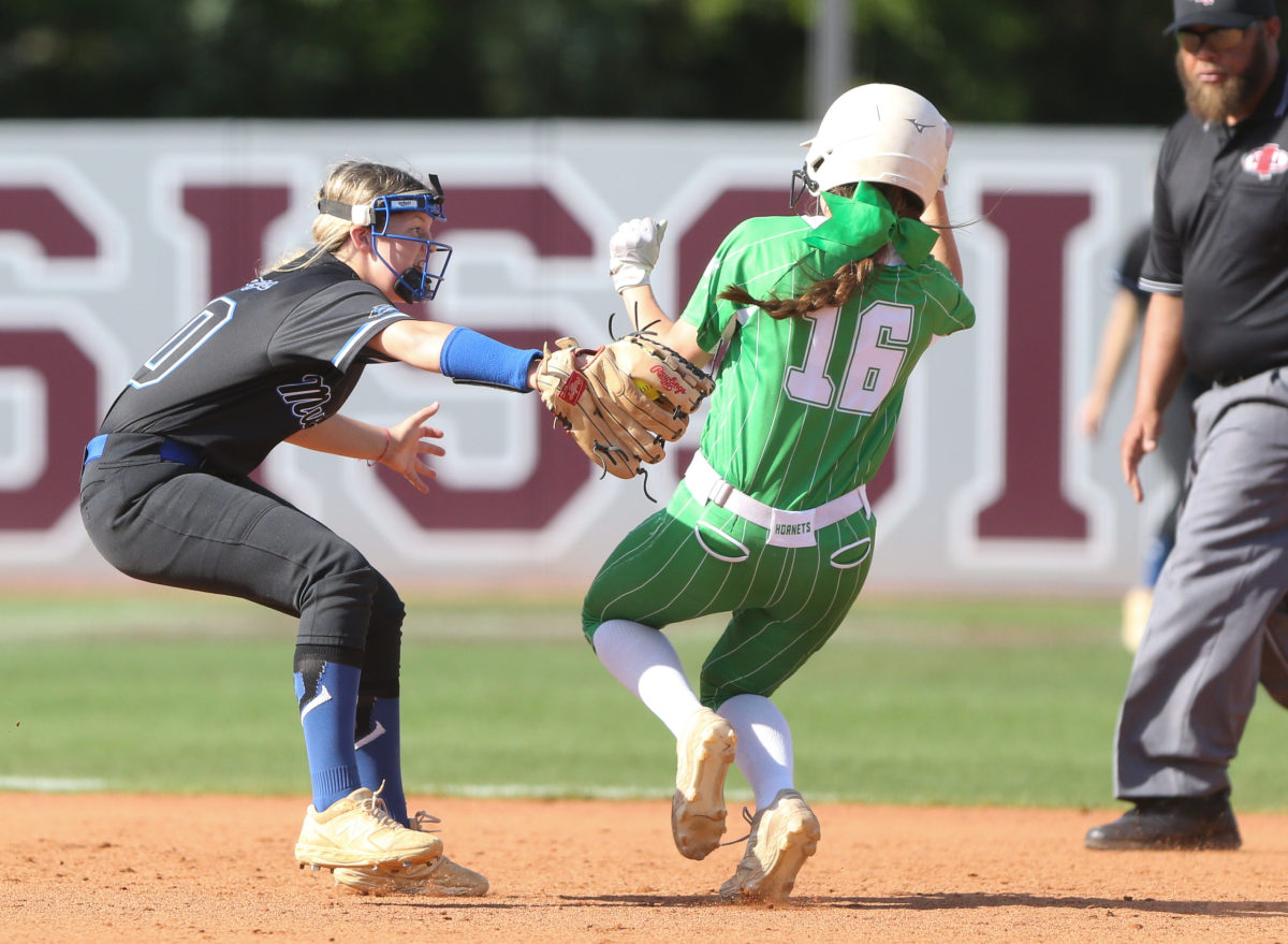 Mantachie High School's Allie  Ensey  (30) attempts to tag Lake High School's Gracie Mckee (16) on a play at second base. Mantachie and Lake played in game one of the MHSAA Class 2A Baseball Championship at Mississippi State University on Wednesday, May 12, 2021. Photo by Keith Warren