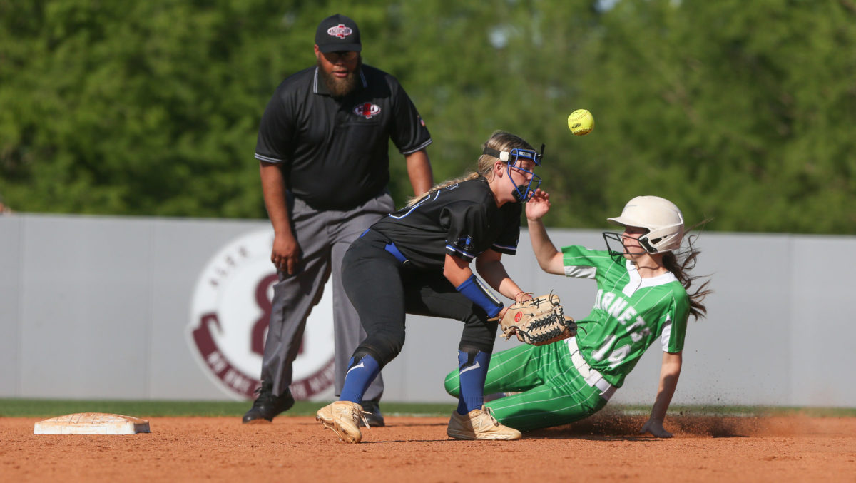 Lake High School's Taylor Clark (14) slides into second base as Mantachie High School's Allie  Ensey  (30) tries to handle the throw. Mantachie and Lake played in game one of the MHSAA Class 2A Baseball Championship at Mississippi State University on Wednesday, May 12, 2021. Photo by Keith Warren