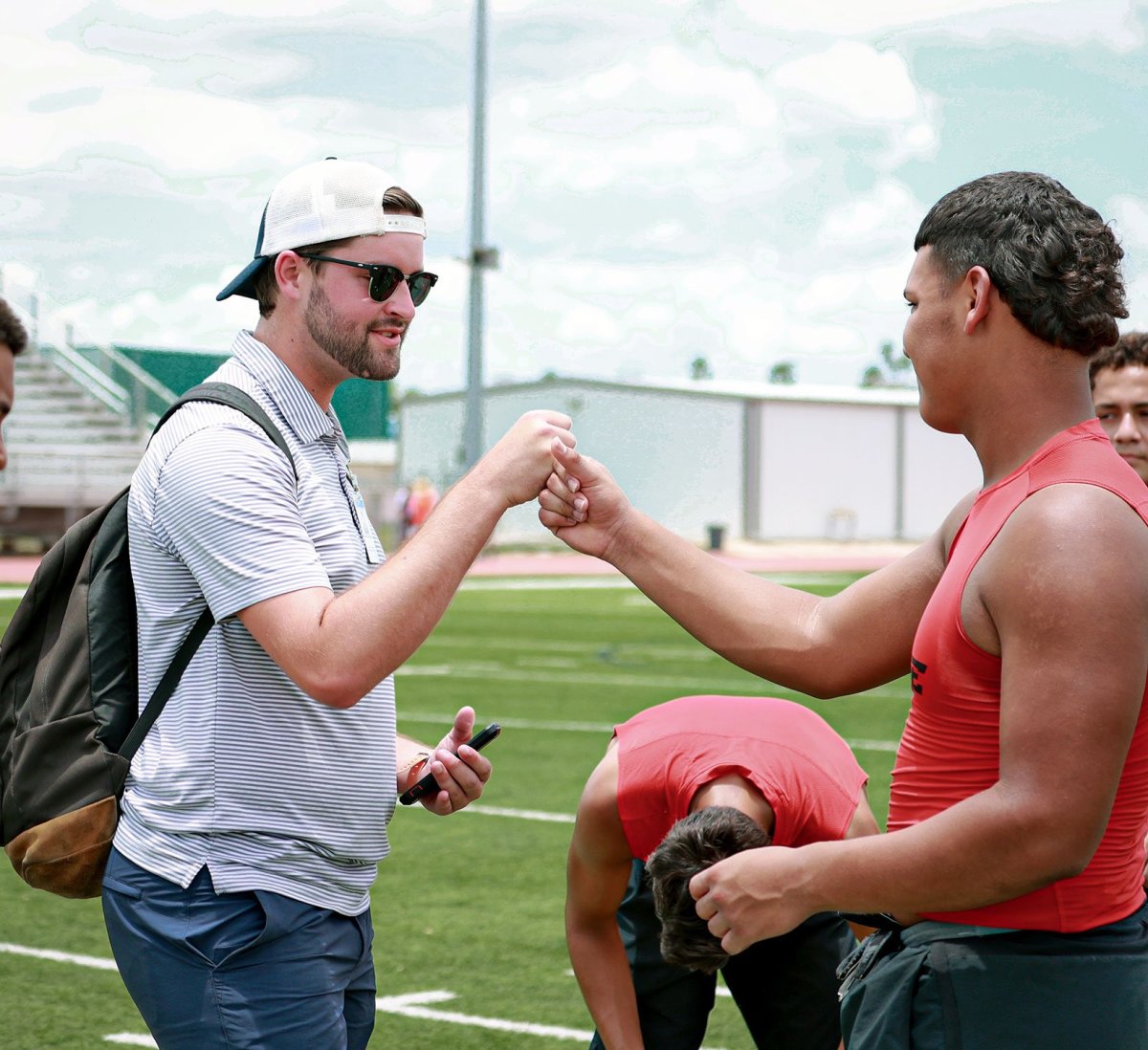 SBLive Texas sports reporter Andrew McCulloch talks to Harlingen Cardinals junior running back Izaiah Bell at the Mid-Valley 7-on-7 State Qualifying Tournament in June in Weslaco. (Photo Courtesy of Brittany Marvin)