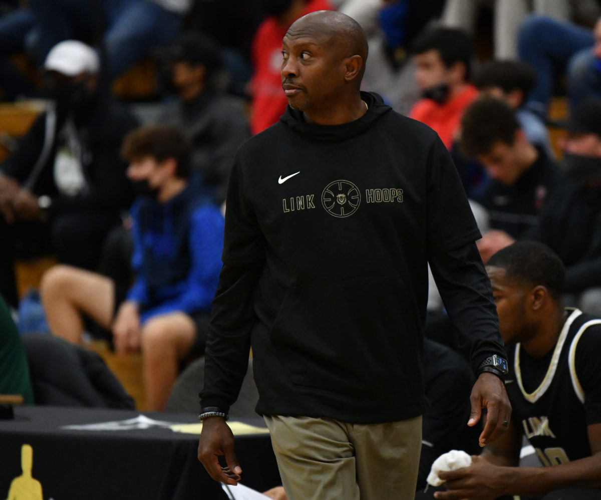Link coach Rodney Perry cases the sidelines in the Les Schwab Invitational. (Photo by Taylor Balkom)