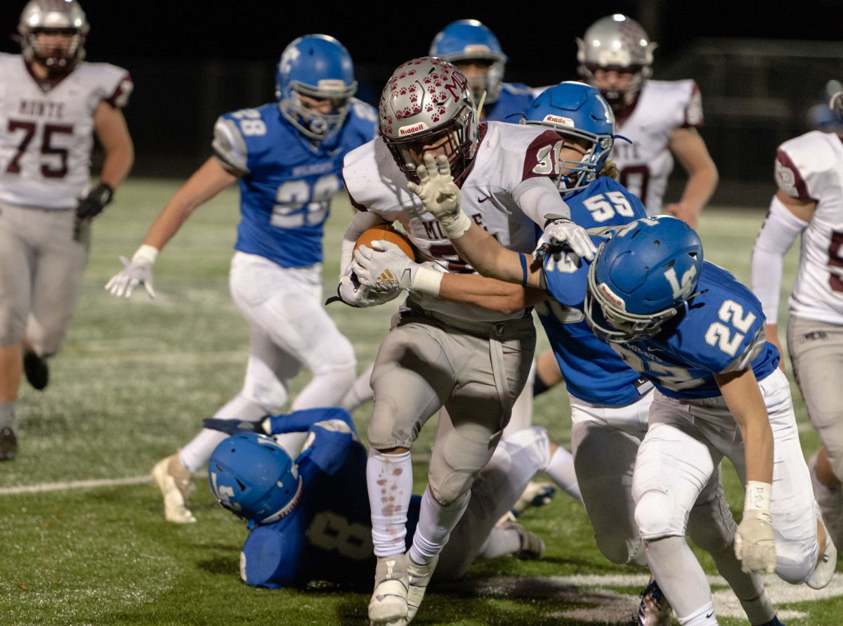 Montesano's Isaiah Pierce pushes away La Center defenders in a 1A Southwest District playoff game on Friday, Nov. 5, 2021, at Beaver Stadium in Woodland. Montesano won 42-20. (Joshua Hart/For ScorebookLive)