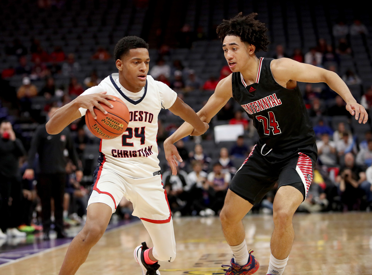 Jamari Phillips drives against Corona Centennial Duke-bound five-star guard Jared McCain in the 2022 CIF Open Division State Championship in March. 