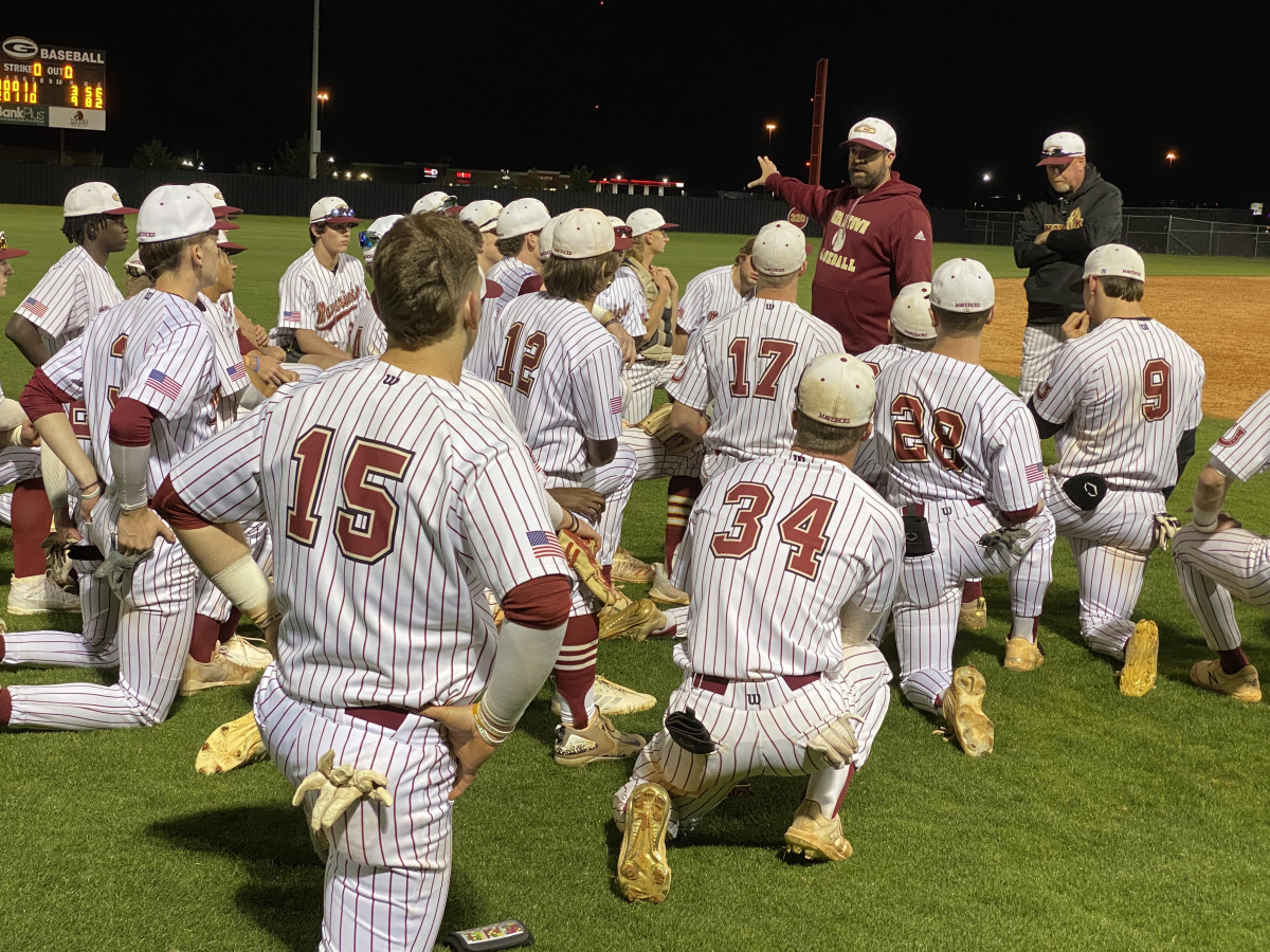 Germantown coach Bryan Hardy talks to his team following the Mavericks' 9-3 win over Madison Central Thursday night in Gluckstadt.