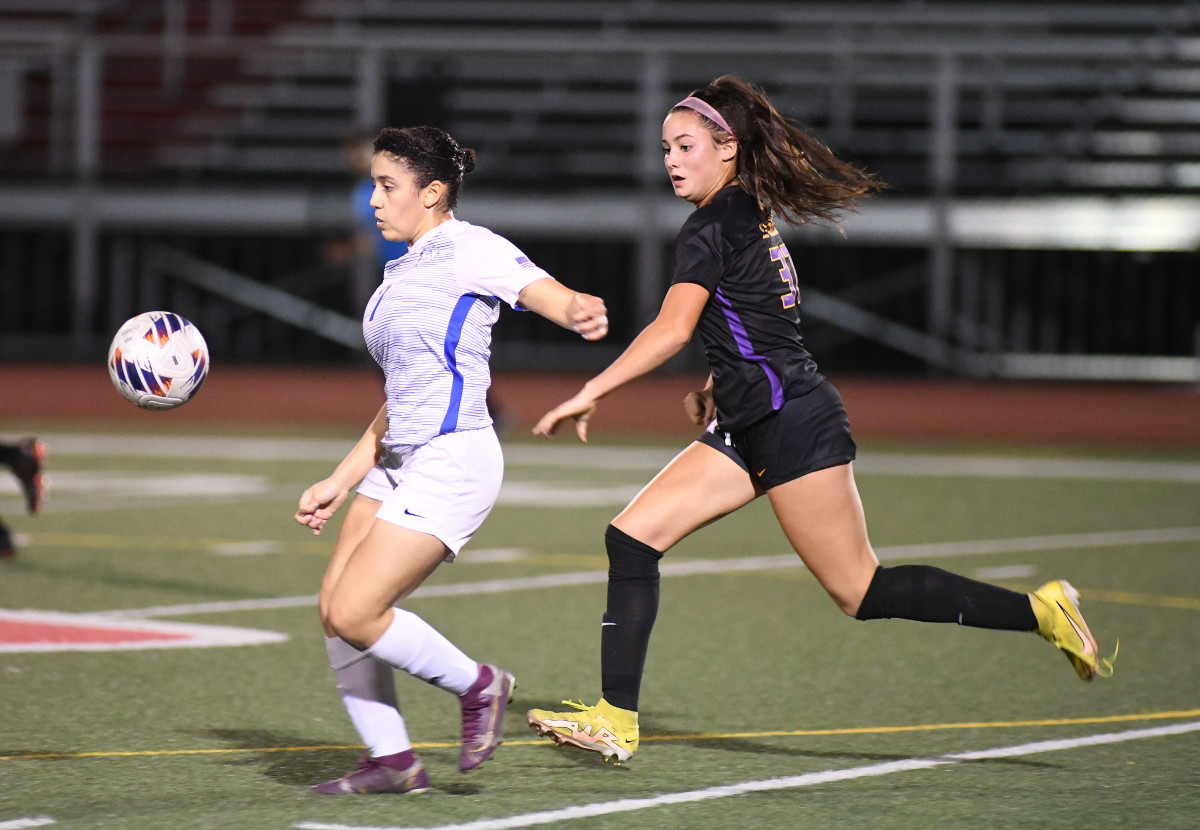 The First Academy's Elizabet Rosario (left) tries to chase down a pass ahead of Montverde defender Sara Zona during Montverde's 5-0 victory.