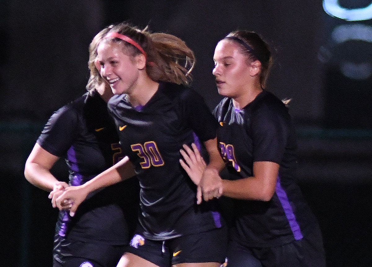 Montverde's Estefania Gonzalez (30) and Antonella Mazziotto Duffaut (39) celebrate a goal by Gonzalez. Mazziotto Duffaut added three goals of her own in the Eagles' 5-0 victory over The First Academy in the Class 3A, District 5 girls soccer championship match.