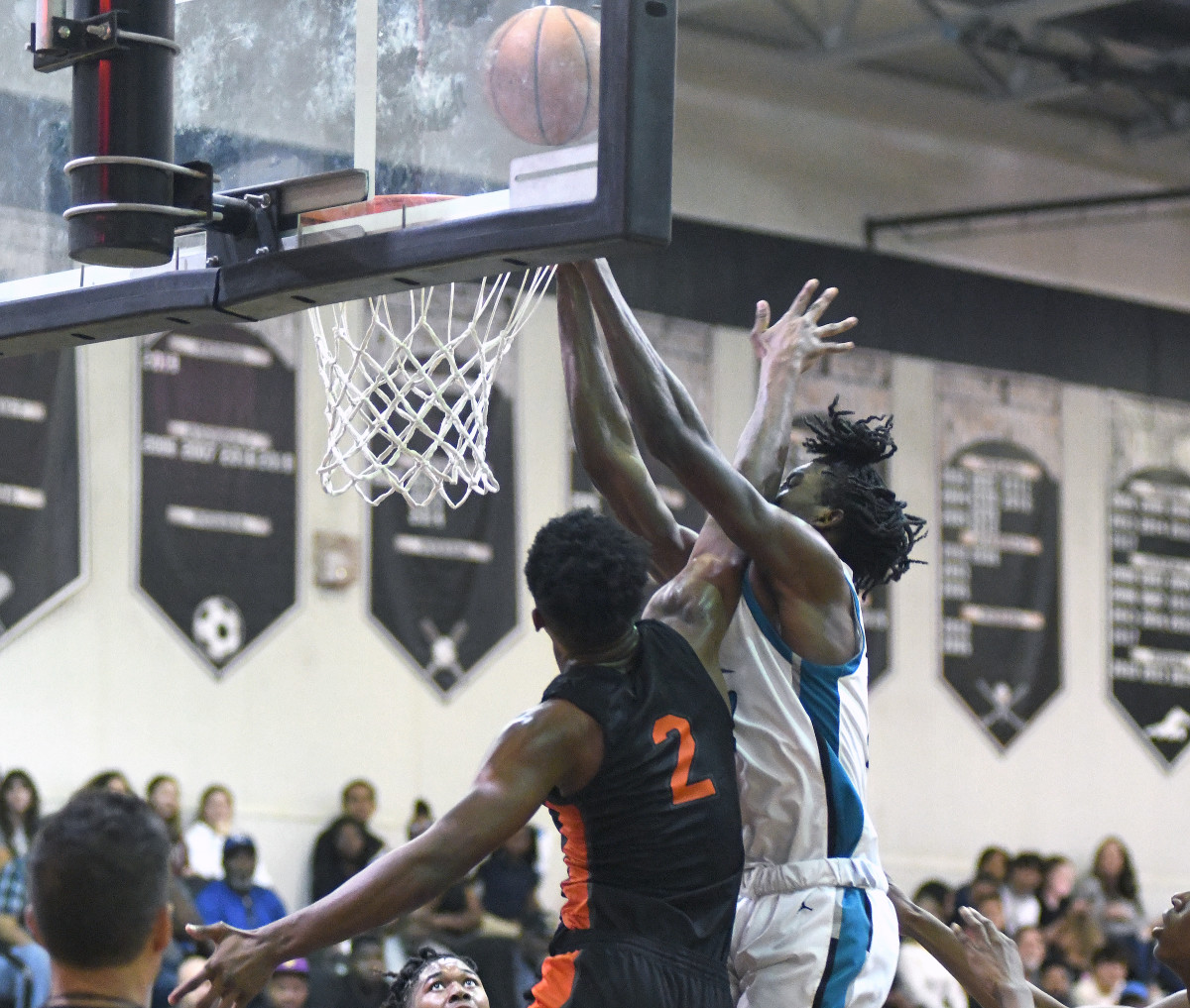 Olympia's Charles Outlaw, right, gets fouled by Leesburg's Camerin James on a dunk attempt in the second quarter. Outlaw had 13 points - including five dunks - and four rebounds for the Titans in their 65-55 victory. James had 14 points and a game-high nine rebounds.