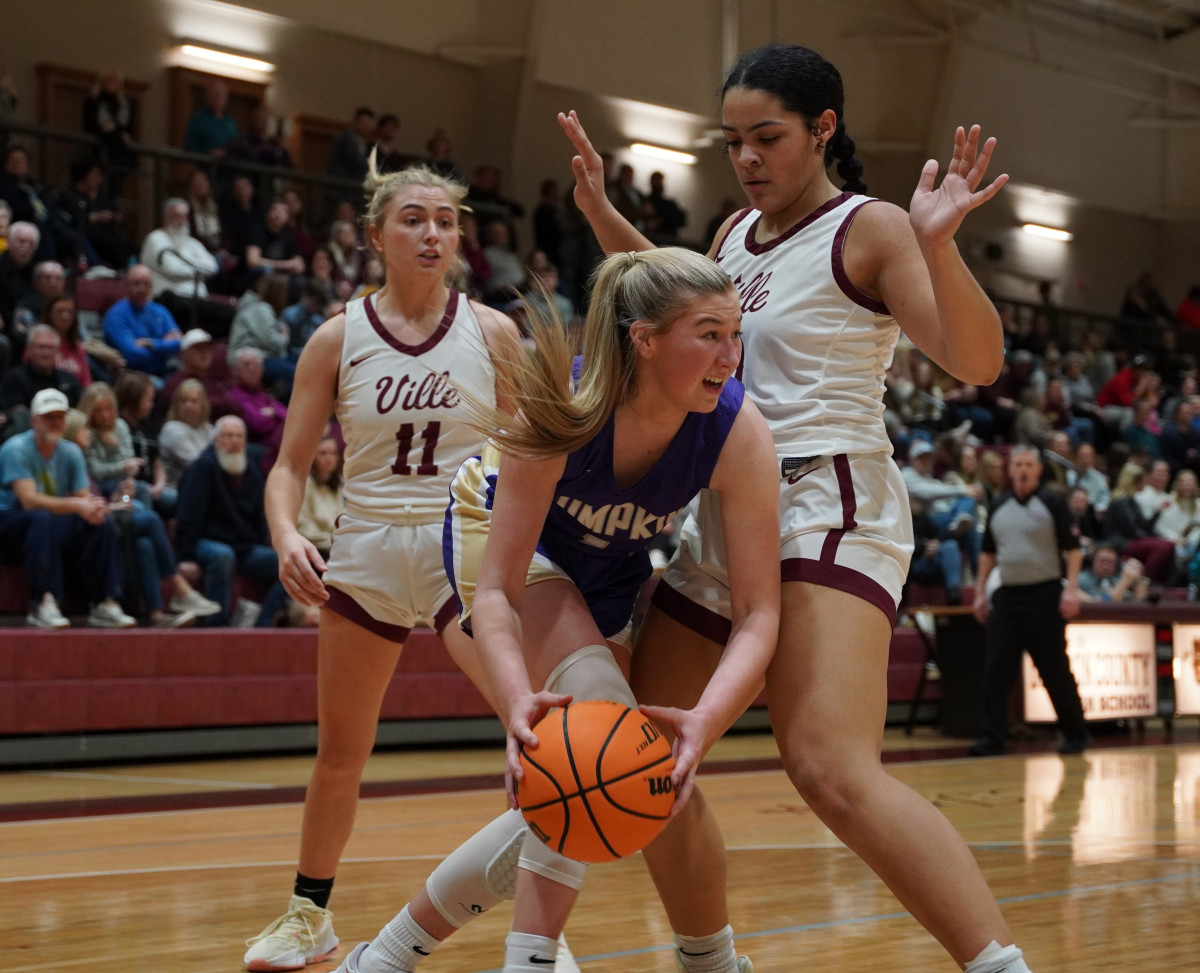 Lumpkin freshman Maddie Lee tries to dribble through tight defense from Dawson. Lee scored eight points for the Indians, all in the third quarter.