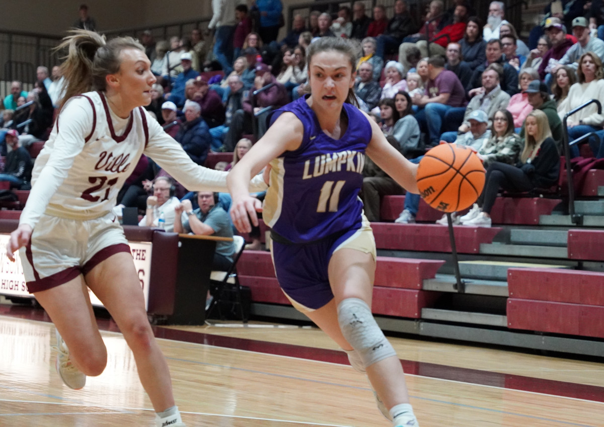 Mary Mullinax drives past Dawson's Abby Slaton with determination on her way to the basket.