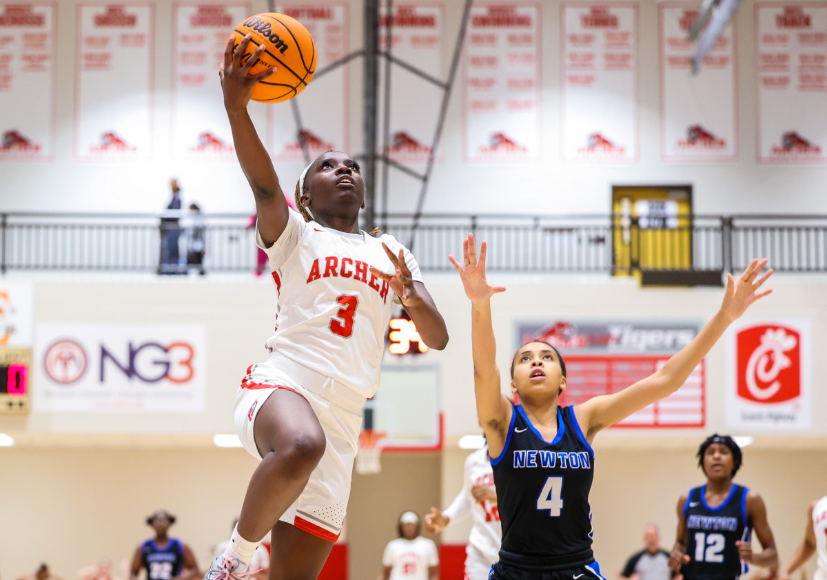 Archer's Taj Hunter soars for an easy two points in the Tigers 69-21 win over Newton.