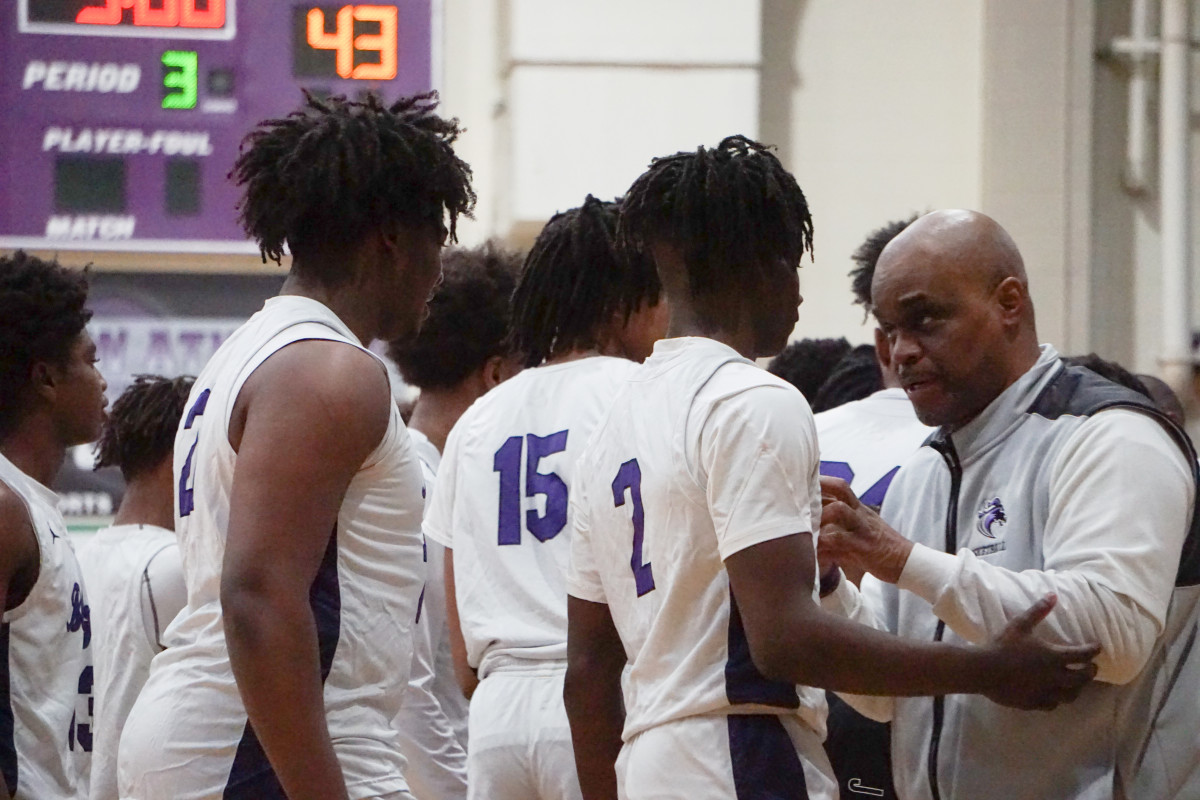 Ridge View head coach Joshua Staley provides Adonis McDaniel (2) some instructions during a timeout on Friday. McDaniel, on the same night he was named Homecoming King, scored 16 points, including 11 in the second half, to lead his team to victory.