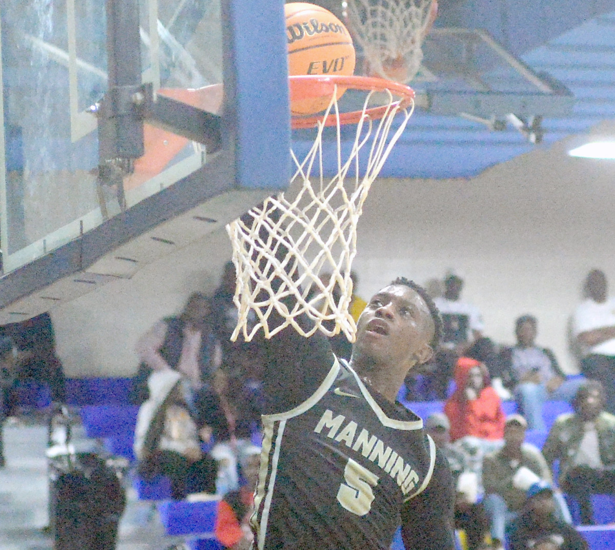 Manning's Justin Daniels goes in for a dunk against Loris.