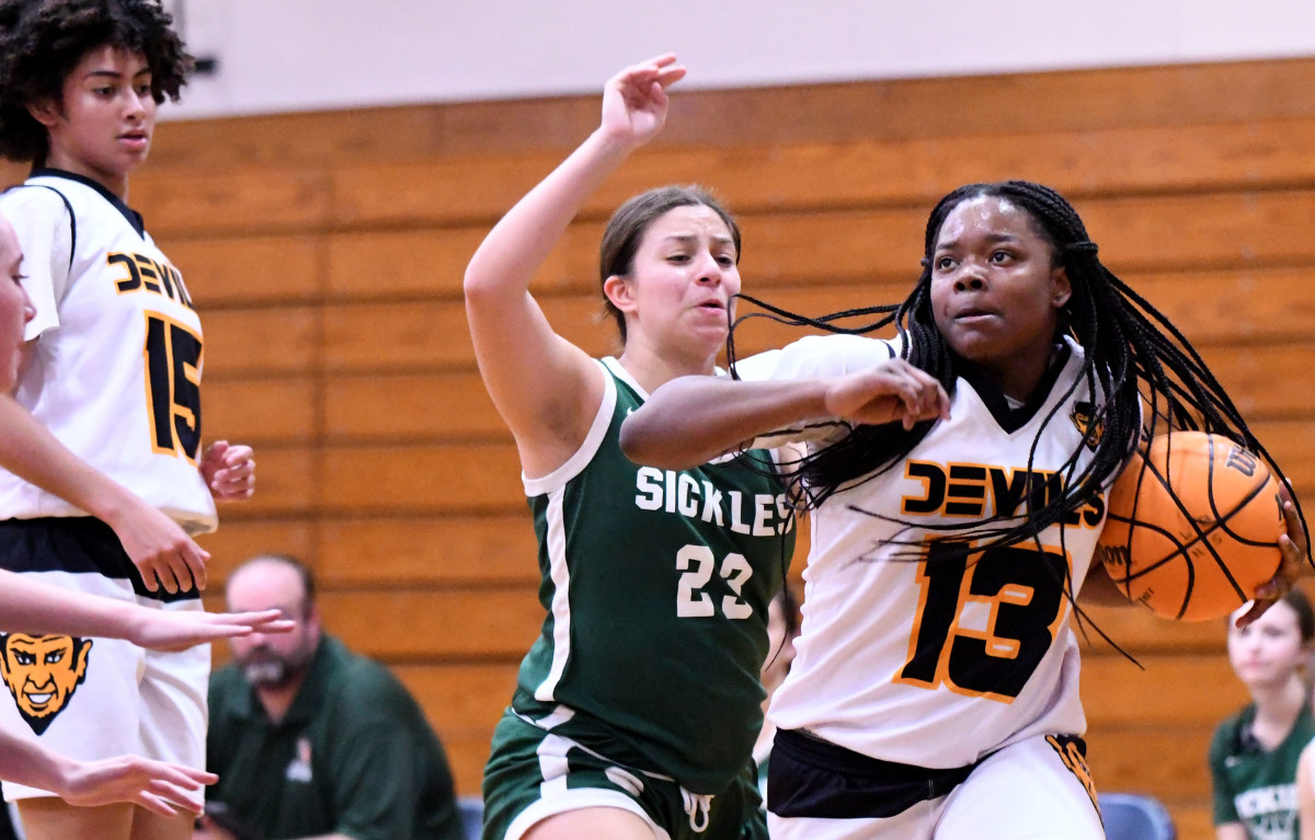 Winter Haven freshman guard Serenity Hardy drives strong to the basket while Tampa Sickles freshman point guard Kelsey Sharpe defends during the first quarter of a girls basketball Class 7A regional quarterfinal against Tampa Sickles on Thursday at Winter Haven.