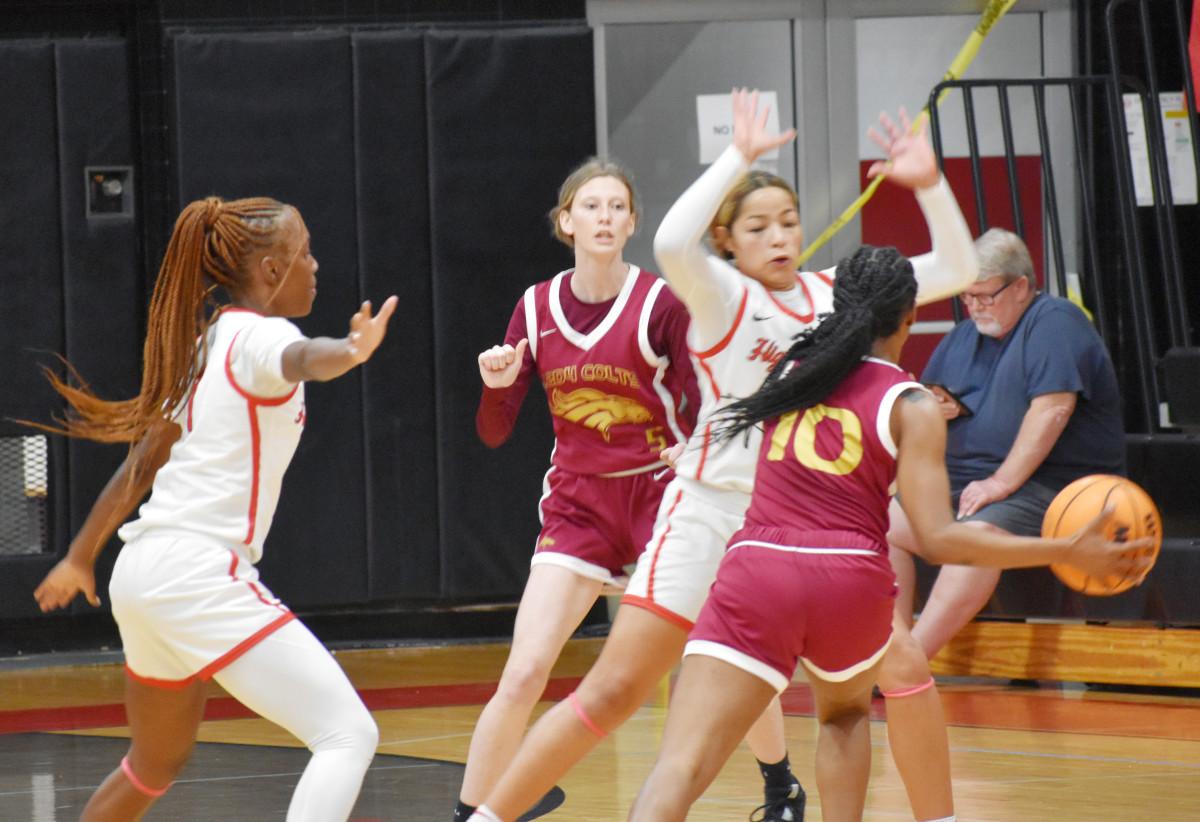 Lake Highland Prep's Eleecia Carter (1) and Camila Depool (3) put the defensive pressure on North Marion's D'nhia Johnson (10) during their Class 4A, Region 2 quarterfinal game on Thursday night. Lake Highland won 90-21.