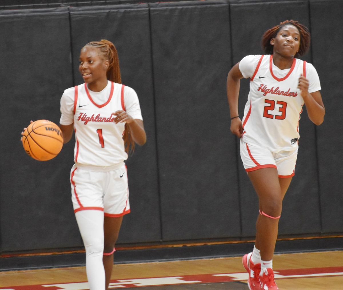 Lake Highland Prep guard Eleecia Carter (1) brings the ball up court alongside teammate Saleigh Simpson (23) during Thursday night's Class 4A, Region 2 quarterfinal game against North Marion.