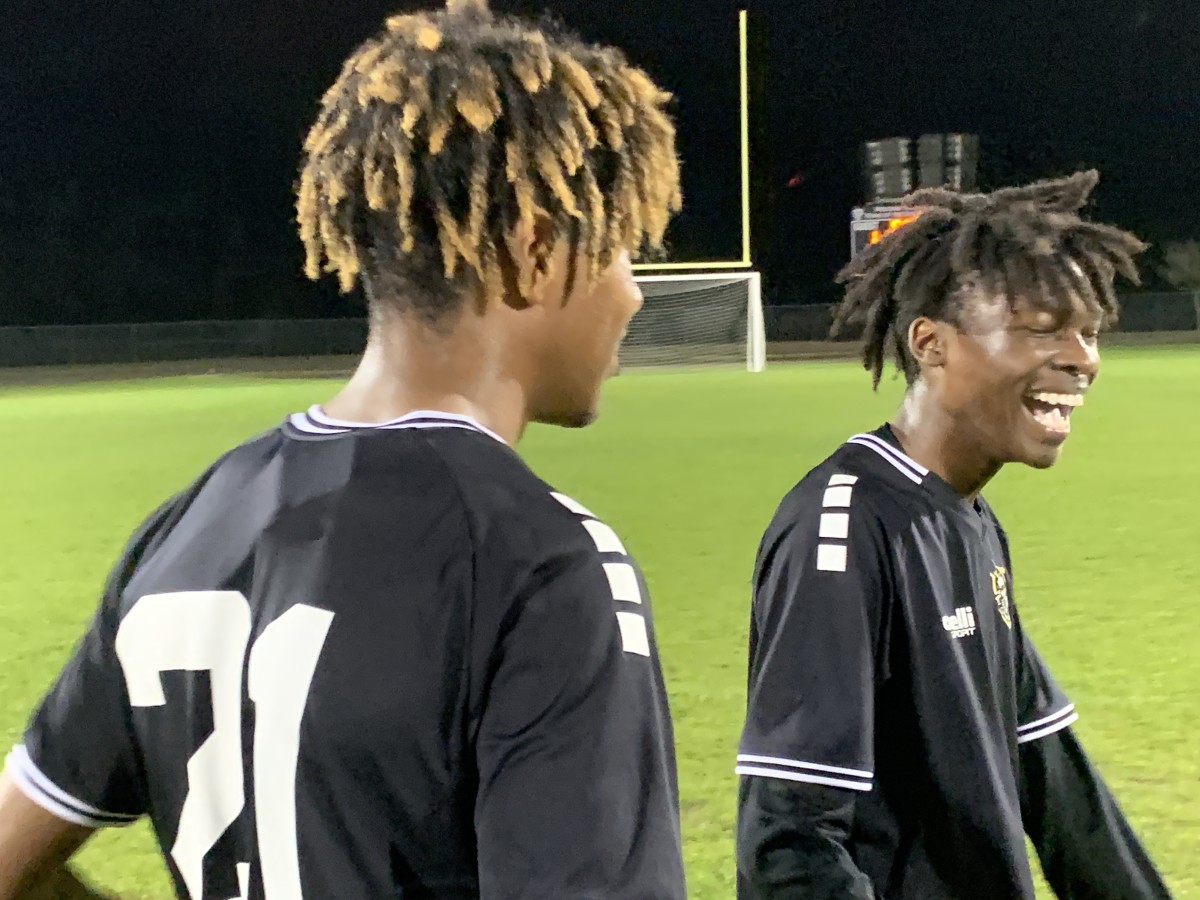East Ridge junior Amir Taylor (right) celebrates the Knights' 3-1 victory over Timber Creek with teammate Elijah Cordner. Taylor had two goals for the Knights.