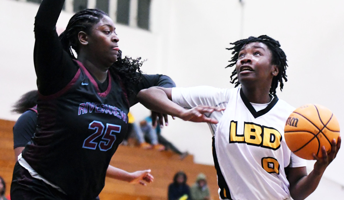 Winter Haven senior power forward Kassadi King prepares to go strong to the basket while Riverview senior center Jaida Cunningham defends during a Class 7A, Region 3 semifinal on Tuesday at Winter Haven.