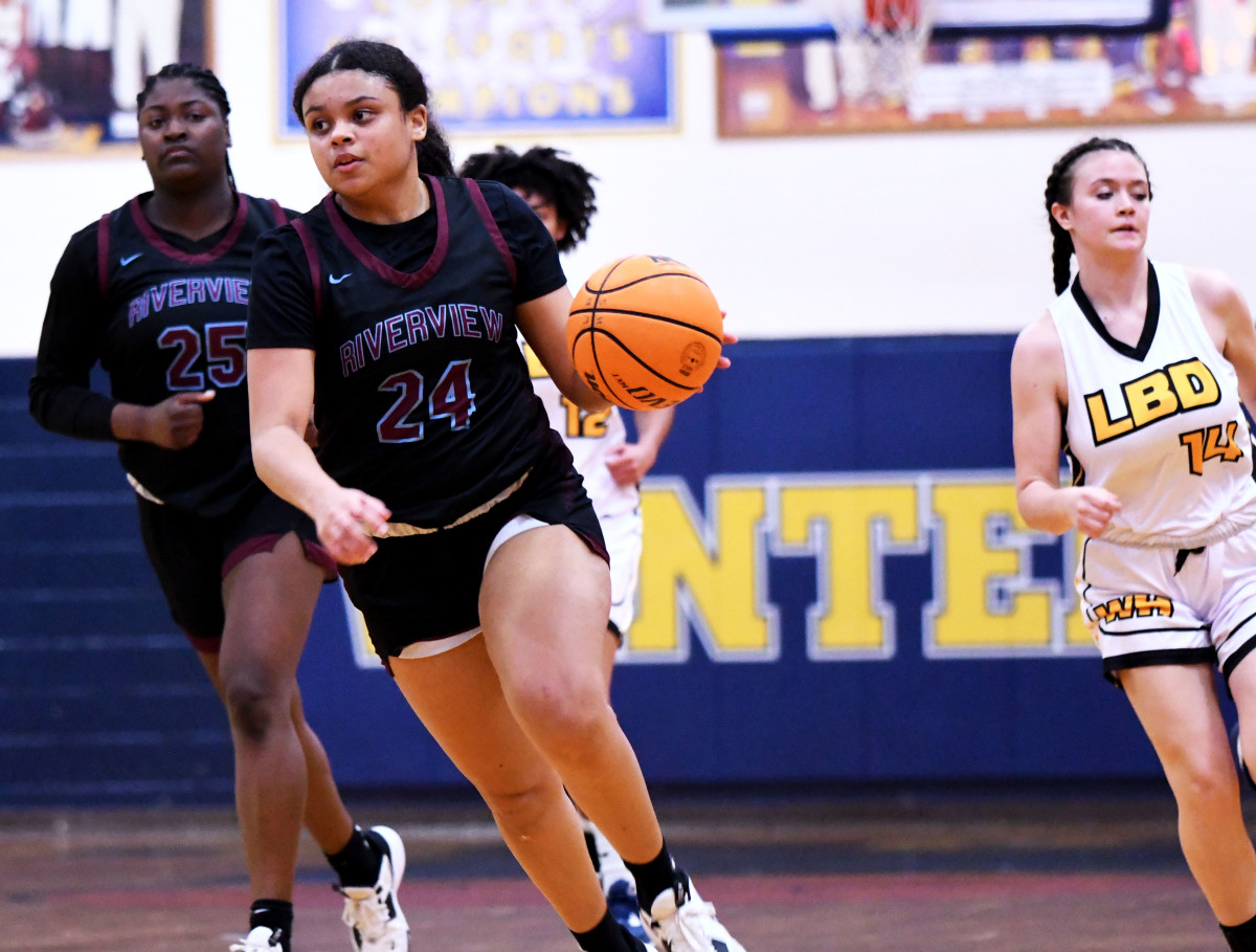 Riverview senior forward Krystal Montas (24) drives to the basket while Winter Haven junior Autumn Brown (14) and Riverview senior center Jaida Cunningham (25) trails during a Class 7A, Region 3 semifinal on Tuesday at Winter Haven.