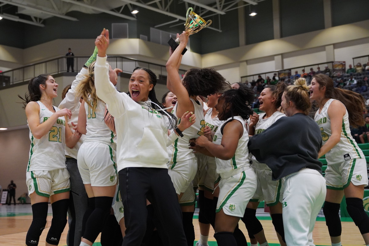 The Buford girls basketball celebrates its Region 8-AAAAAAA championship game victory over Central Gwinnett.