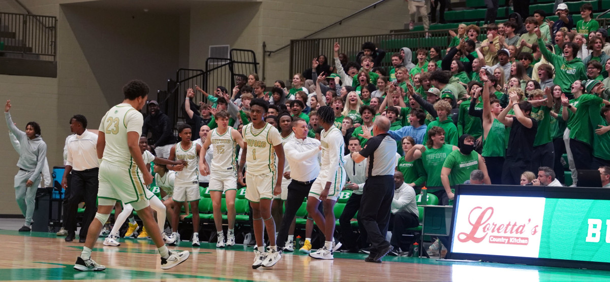 After hitting the eventual game-winning shot, Chase Robinson celebrates in front of his team and a frenzied crowd.