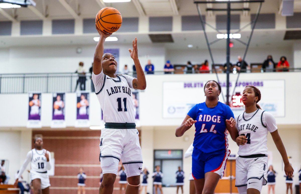 Norcross's Veronaye Charlton (11) goes up for an easy two, as teammate Jania Akins (24) and Peachtree Ridge's Aaliyah Hunt (44) look on. Charlton and Akins combined for 36 points in their team's victory.