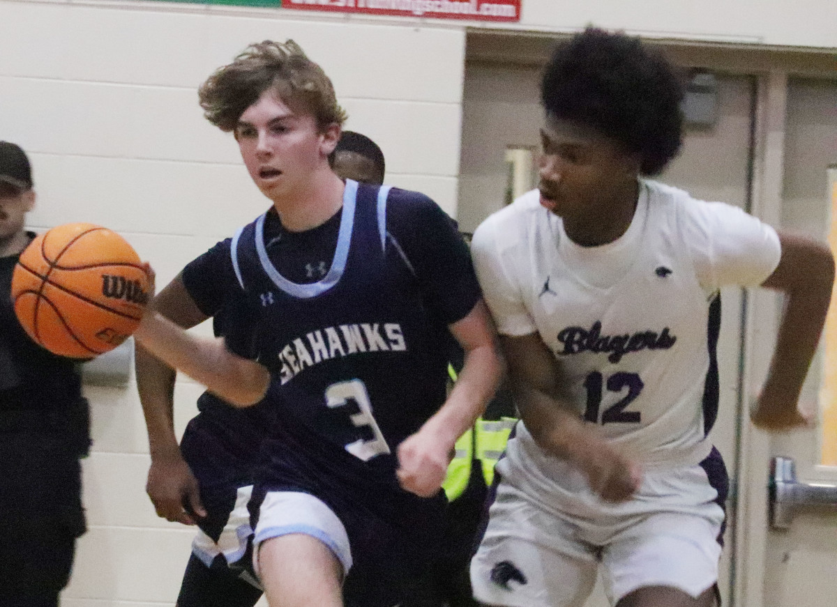 Ridge View's Korie Corbett (12) worked hard on both ends of the court, here playing tough defense against Hilton Head Island's Luke Danzell, while scoring a game-high 24 points on the offensive end.