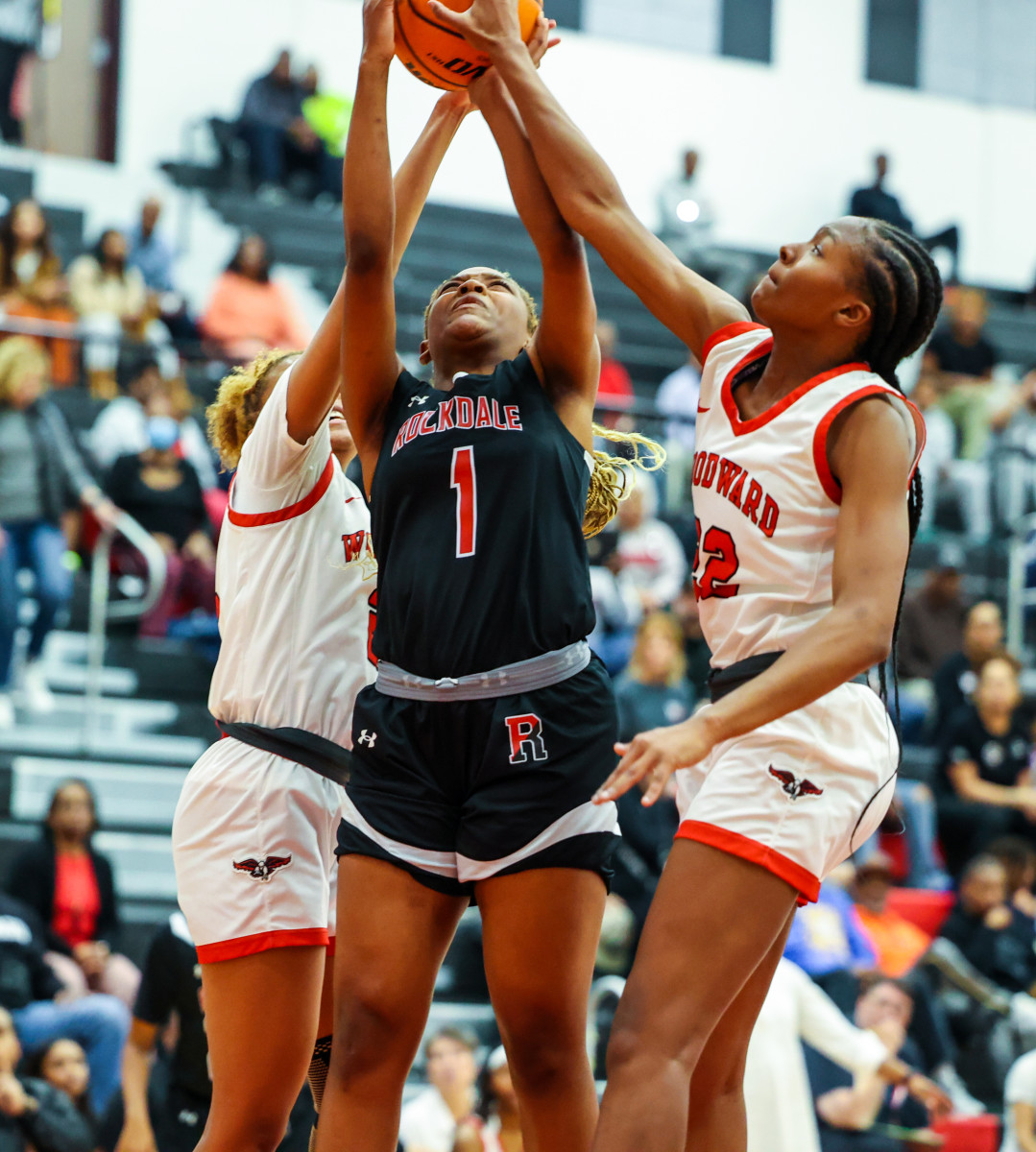 Rockdale County's Madison Presha (1) fights through a double team to get off a shot against Woodward Academy. She scored 13 points in the win.