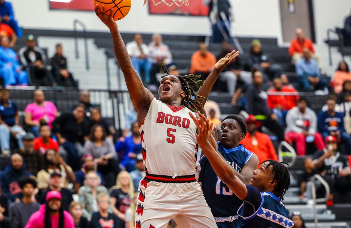 JaQuez Akins lays in two of his 19 points during Jonesboro's victory over Lovejoy in the Region 3-AAAAAA title game. He was one of four Cardinals scoring in double figures.