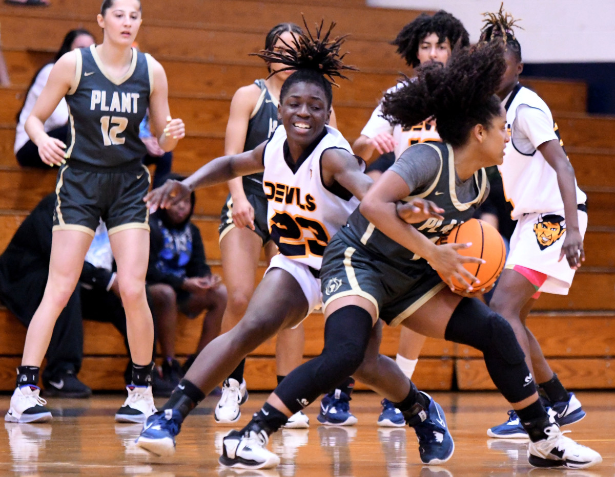 Winter Haven senior guard Bre'Asia Washington attempts to steal the ball from Tampa Plant guard Azzariah Styles during Class 7A, Region 3 final on Friday at Winter Haven.