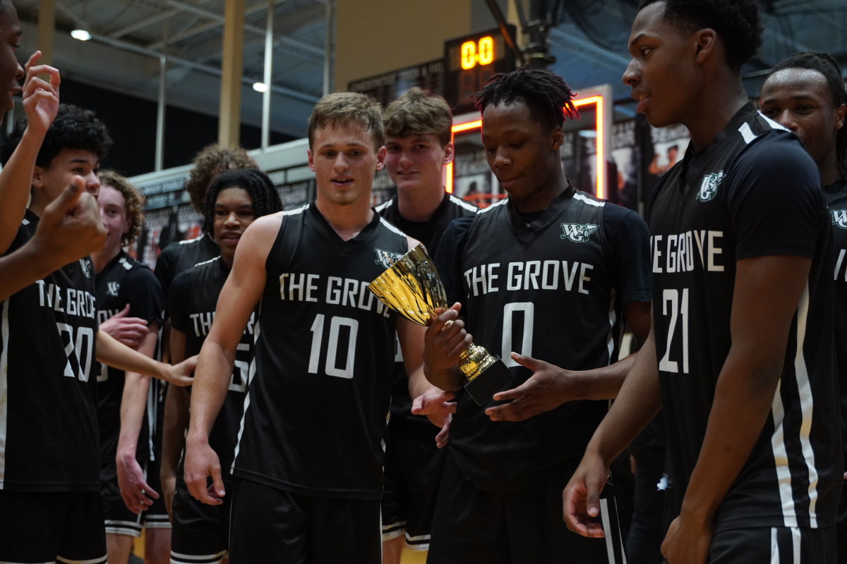 Walnut Grove players admire their regional championship trophy after the comeback win over Madison County in the final.