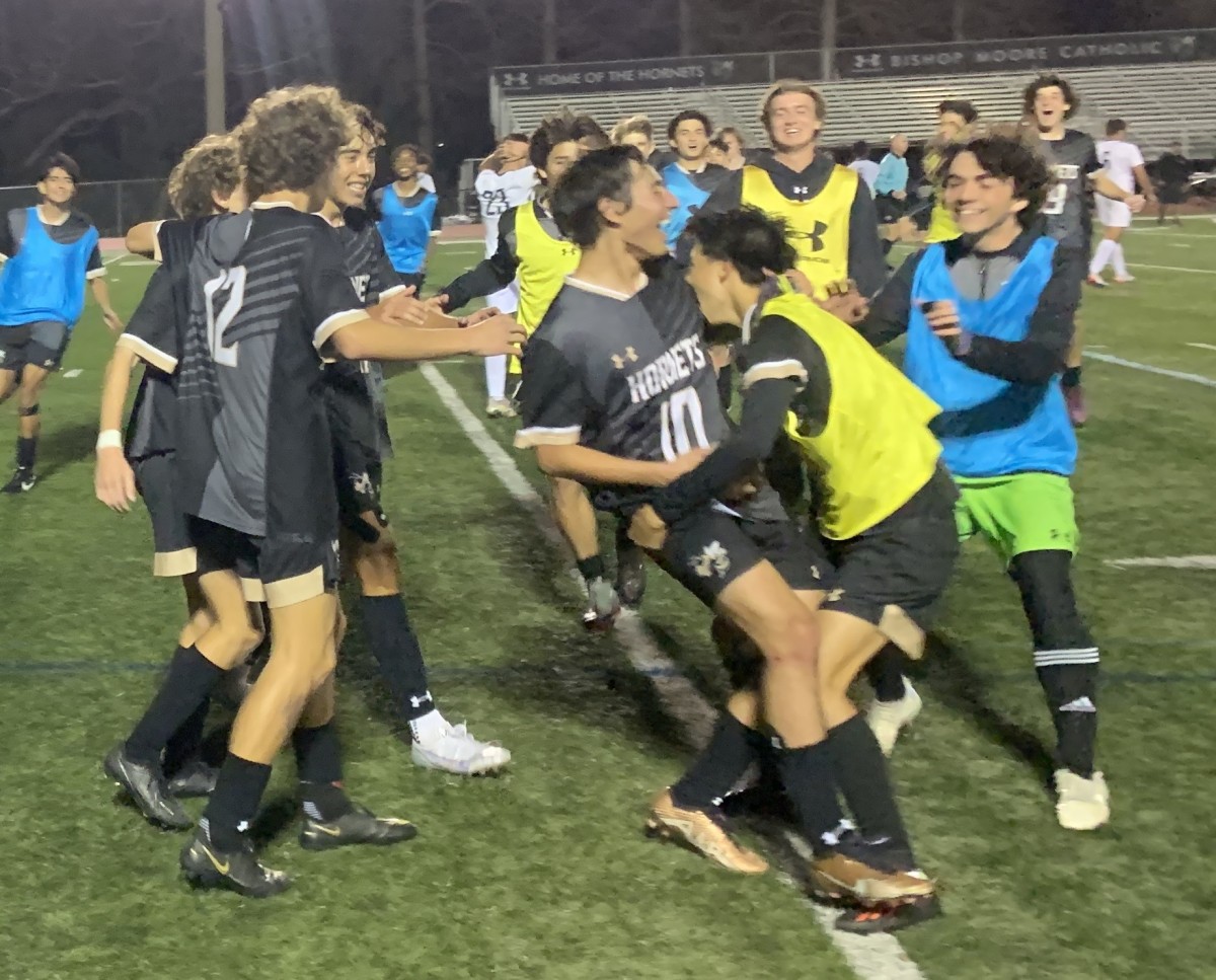 Bishop More celebrates its victory in Saturday's Class 4A boys soccer state semifinal. The Hornets will face Gulliver Prep in Thursday's state title game.