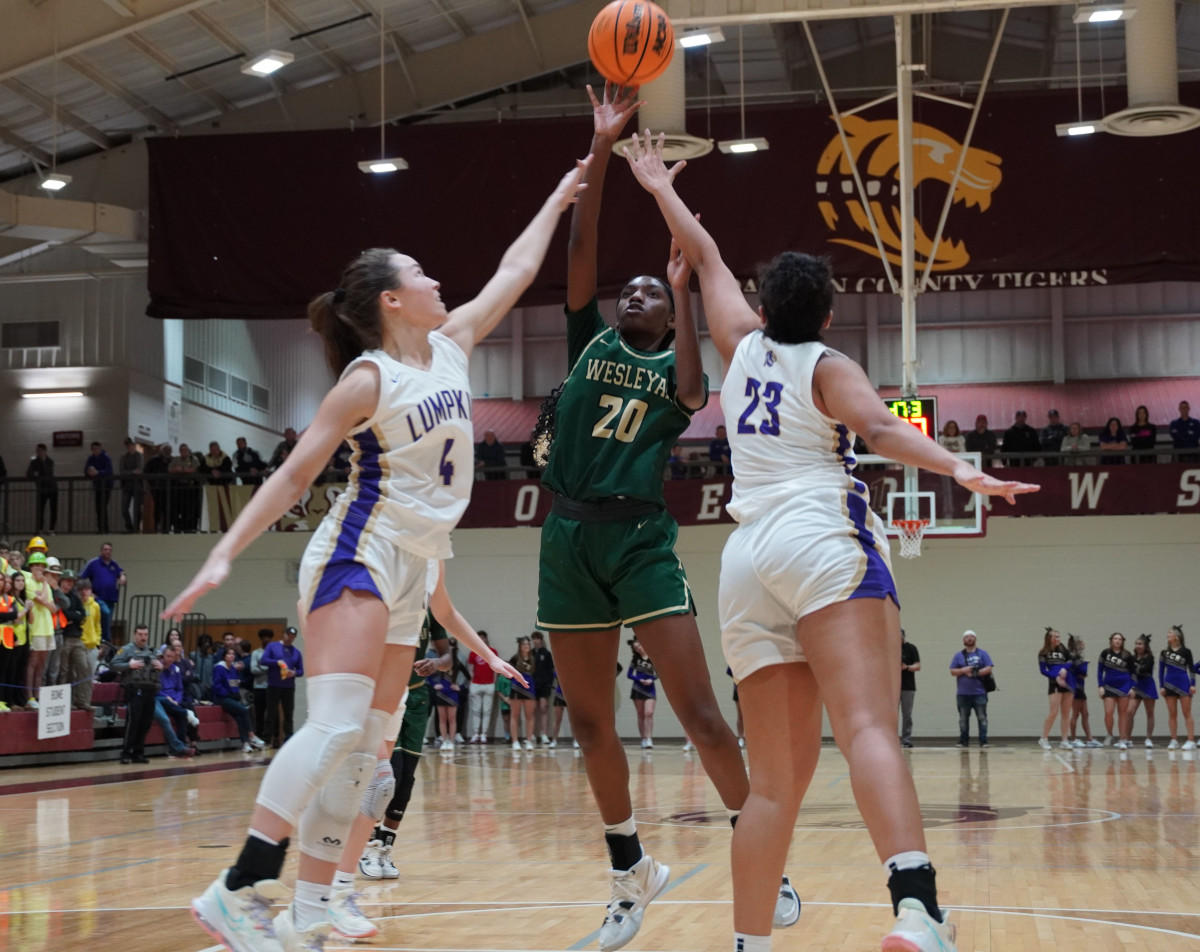 Johanna Potter puts up a shot against the Lumpkin double team. The Indians had no answer for Potter in the second half, scoring 12 of her 19 points in the third quarter and pacing the Wolves to a Region title.