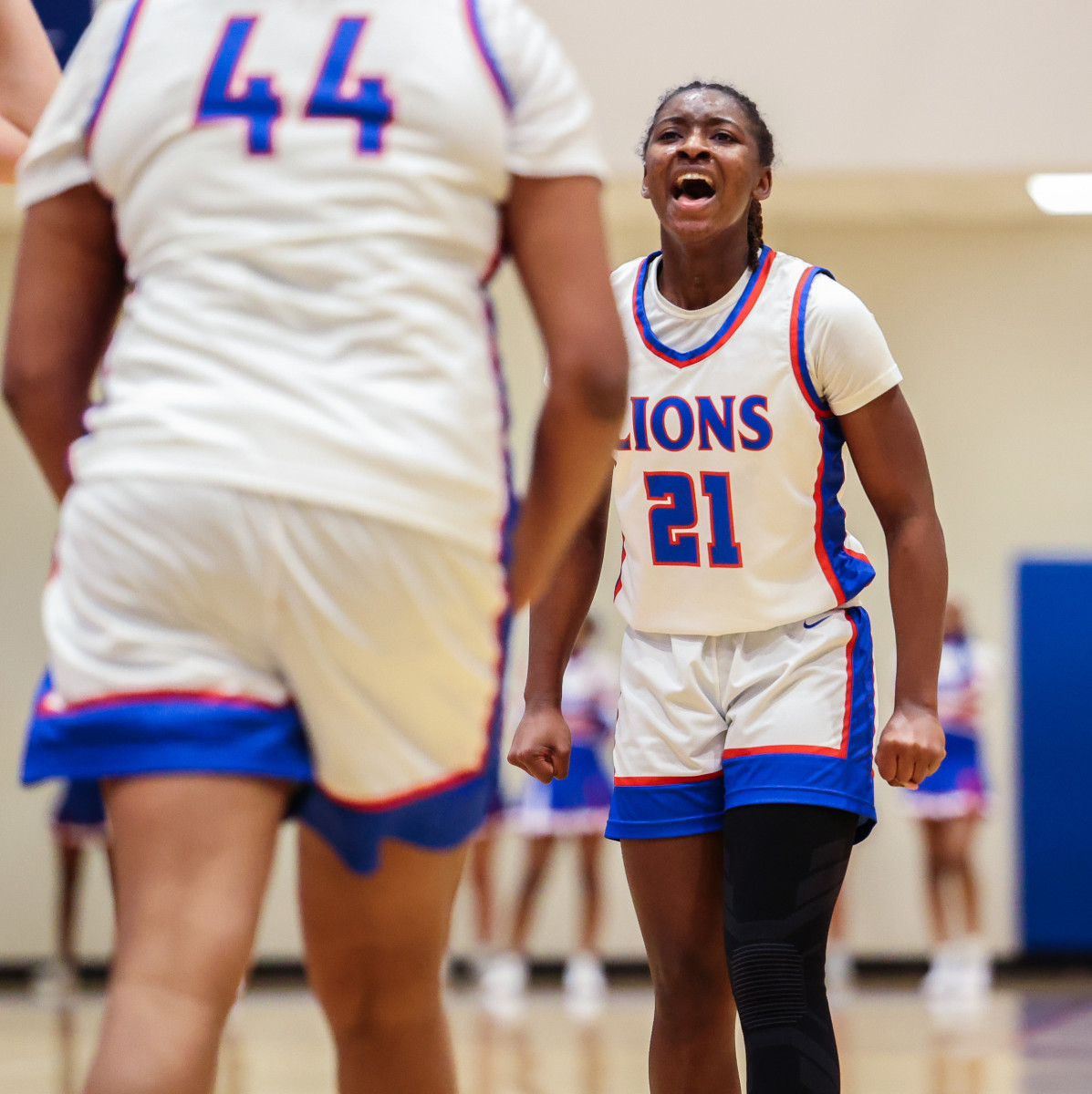 Peachtree Ridge's Sanaa Tripp (21) lets out a celebratory yell in the direction of teammate Aaliyah Hunt (13). The two combined for 32 points, with netting a team-high 19.