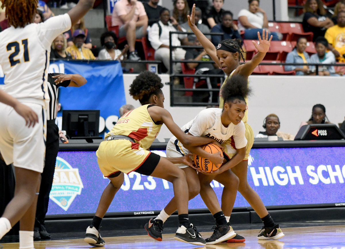 St. Thomas Aquinas junior Kamryn Corporan fights for control of the ball with Lake Gibson’s Jamila Ray at the FHSAA Class 6A girls basketball state semifinals on Thursday at the RP Funding Center in Lakeland.