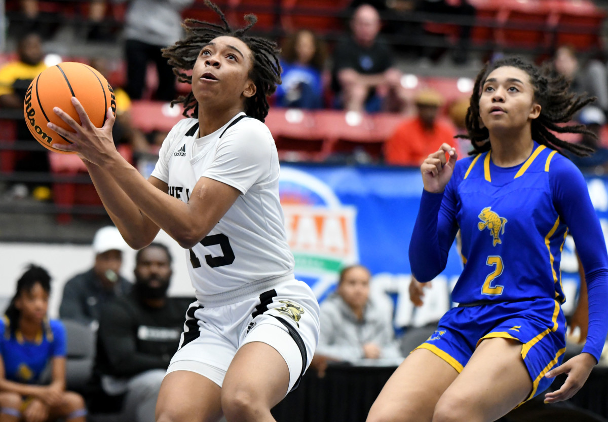 Oakleaf guard Fantasia James goes up for a shot while Charlotte guard Kamie Ellis trails on defense at the FHSAA Class 6A girls basketball state semifinals on Thursday at the RP Funding Center in Lakeland.