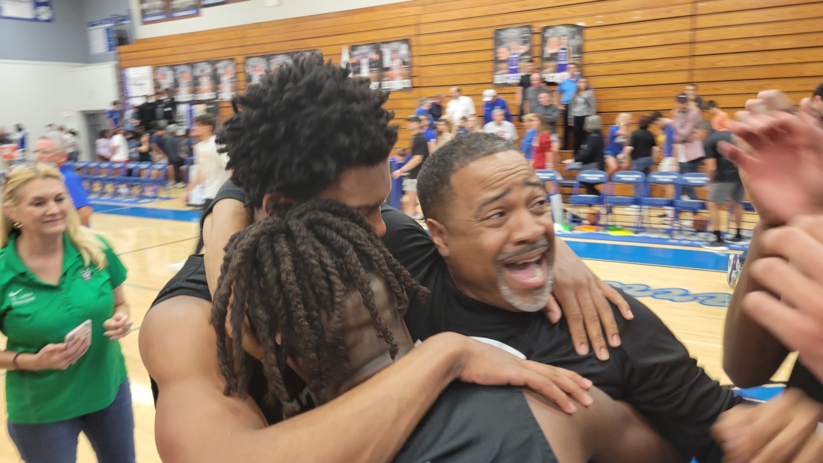 St. Petersburg coach Chris Blackwell embraces his players as they celebrated their Class 5A-Region 3 championship game victory over Barron Collier.