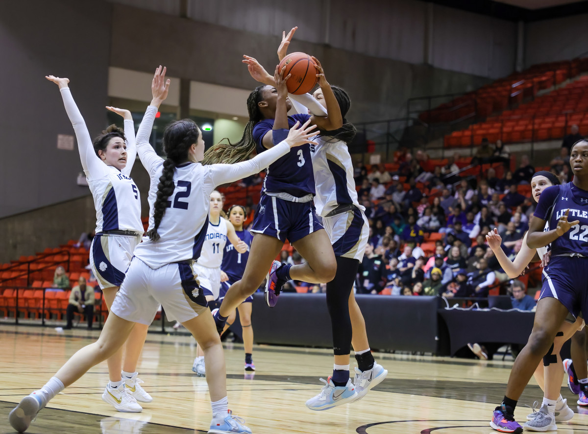 Amarachi Kimpson drives to the hoop through a sea of defenders in the UIL Region 1 semifinals.
