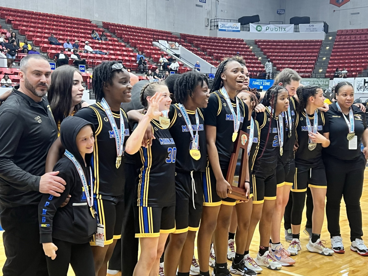 As exhausted as they were exhilerated, the Mainland Buccaneers pose with their 5A state championship trophy and medals.