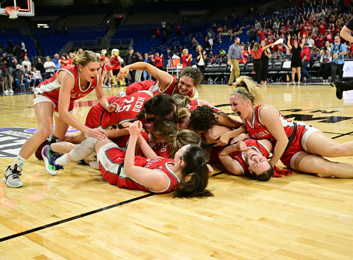 Jalynn Bristow lays beneath a dogpile at the AlamoDome after her 21 points and 14 boards led Holliday to its first Class 3A UIL state title in March.