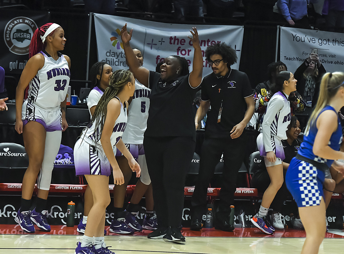 Africentric girls basketball coach Janicia Anderson and her players start to celebrate as time ticks down in the 2023 OHSAA Division III state championship game. Africentric defeated Chippewa 75-62 to claim the state title.