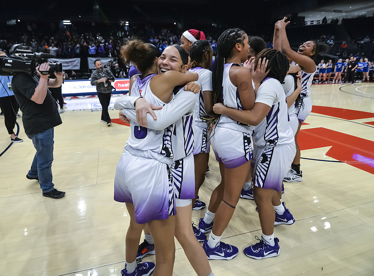 Africentric girls basketball players celebrate winning the 2023 Division III state championship.