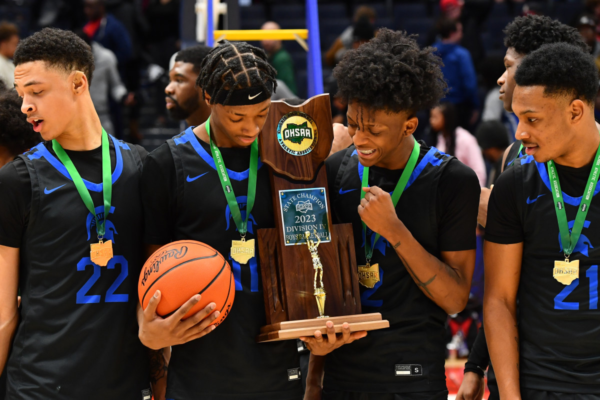 Richmond Heights players look at the OHSAA Division IV state championship trophy after winning with a victory over Crestview on March 19, 2023.
