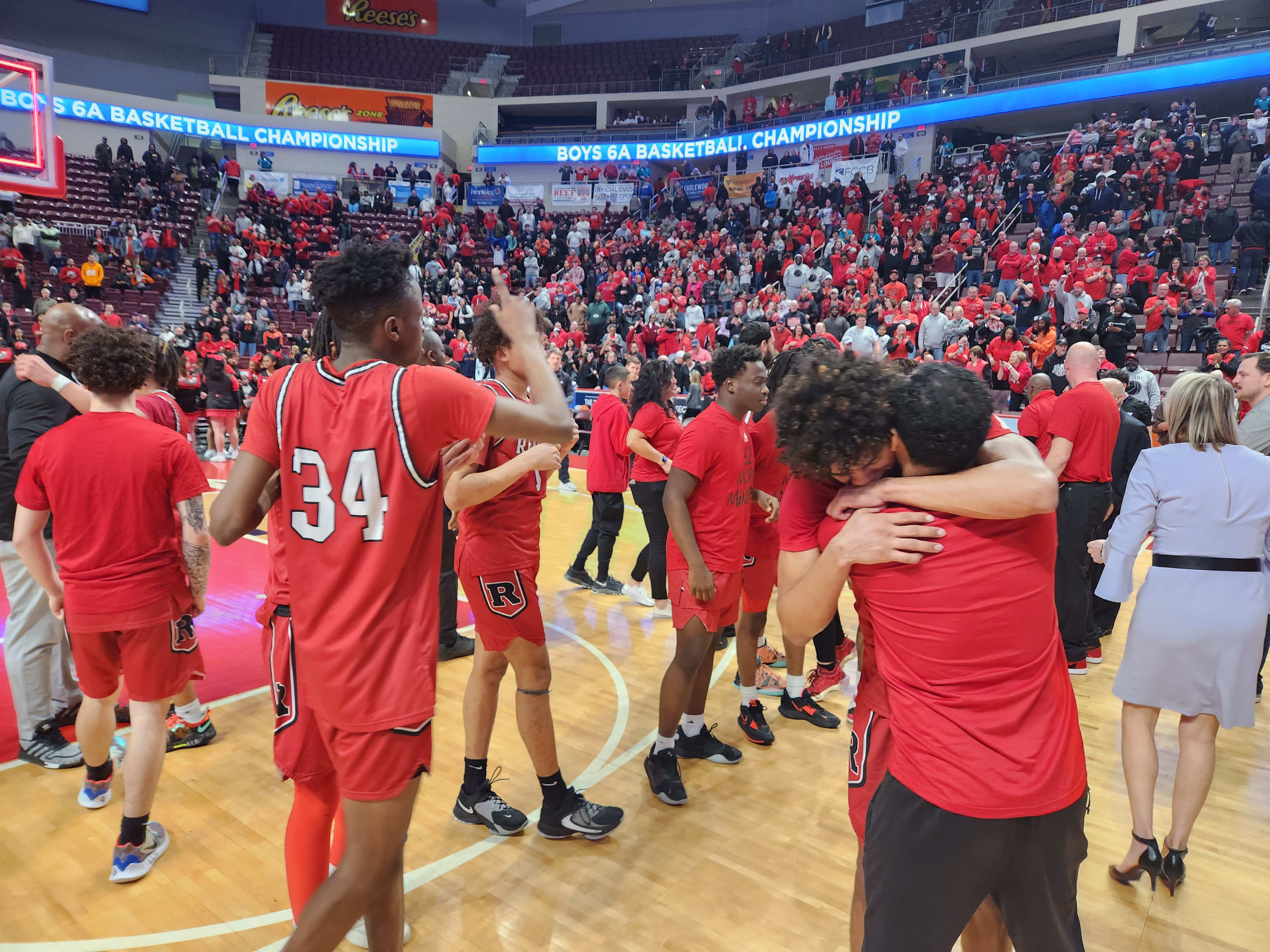 Reading players celebrate winning the 2023 PIAA Class 6A basketball state championship.