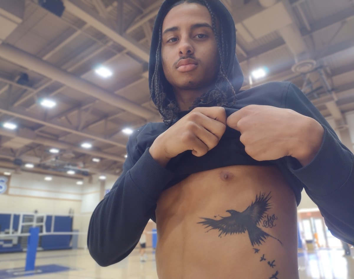 Damon Potter shows off his Raven tattoo in honor of his grandfather. Photo: John Murphy