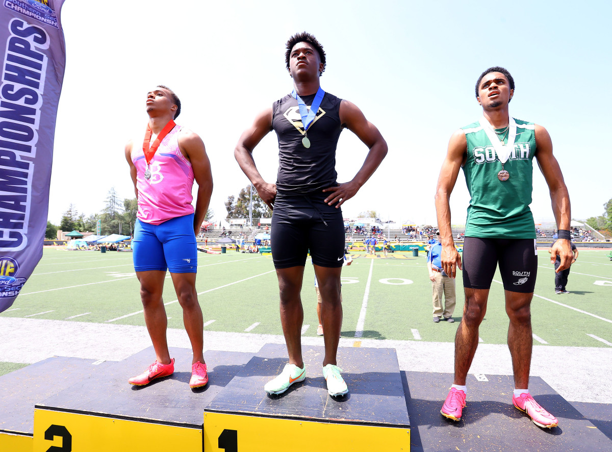 Rodrick Pleasant stands tall on top of podium at last week's Southern Section Masters Meet at Moorpark High School. From L-R: Long Beach Jordan's Jordan Washington, Pleasant and Anthony Flores of South Torrance. Photo: Nick Koza. 