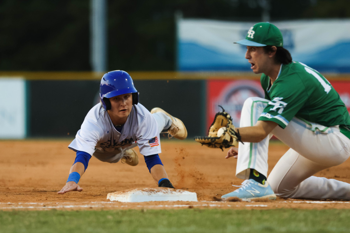 A West Henderson baserunner tries to get back to the bag during a pickoff attempt.