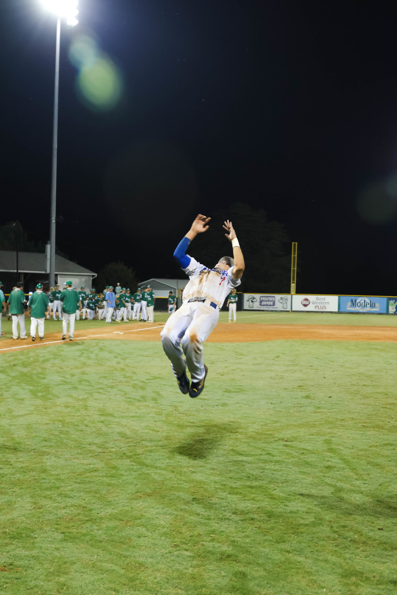 A West Henderson player does a back flip following Friday night's win in Game 1 of the NCHSAA 3-A state championship series.